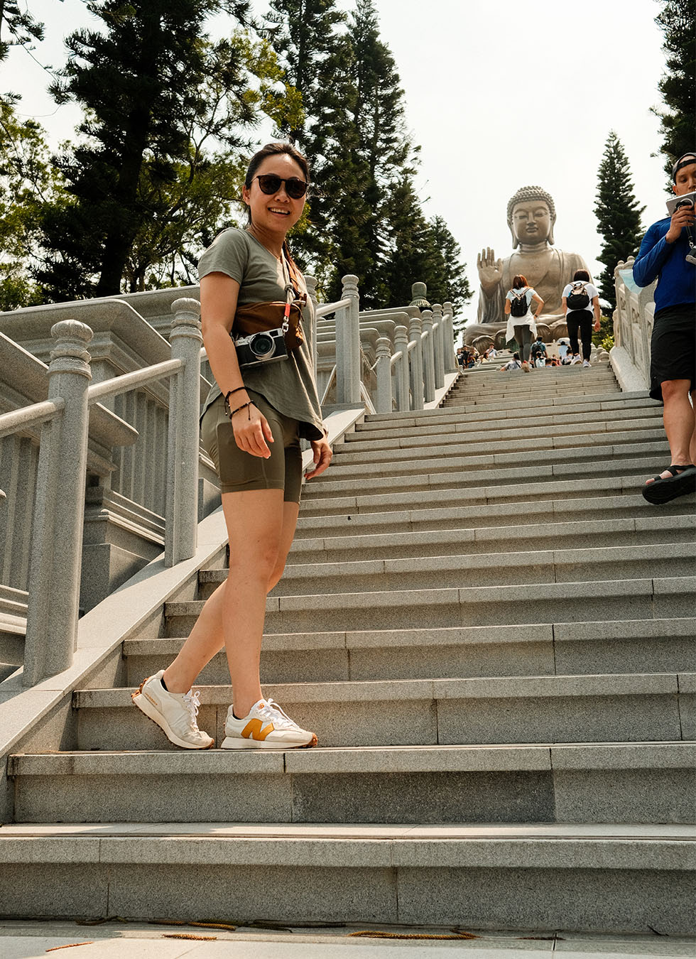 Maggie on stairs and Buddha in the background