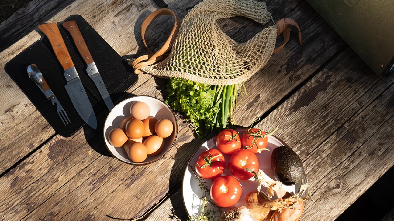 Elevated camping cooking ingredients on a wooden table