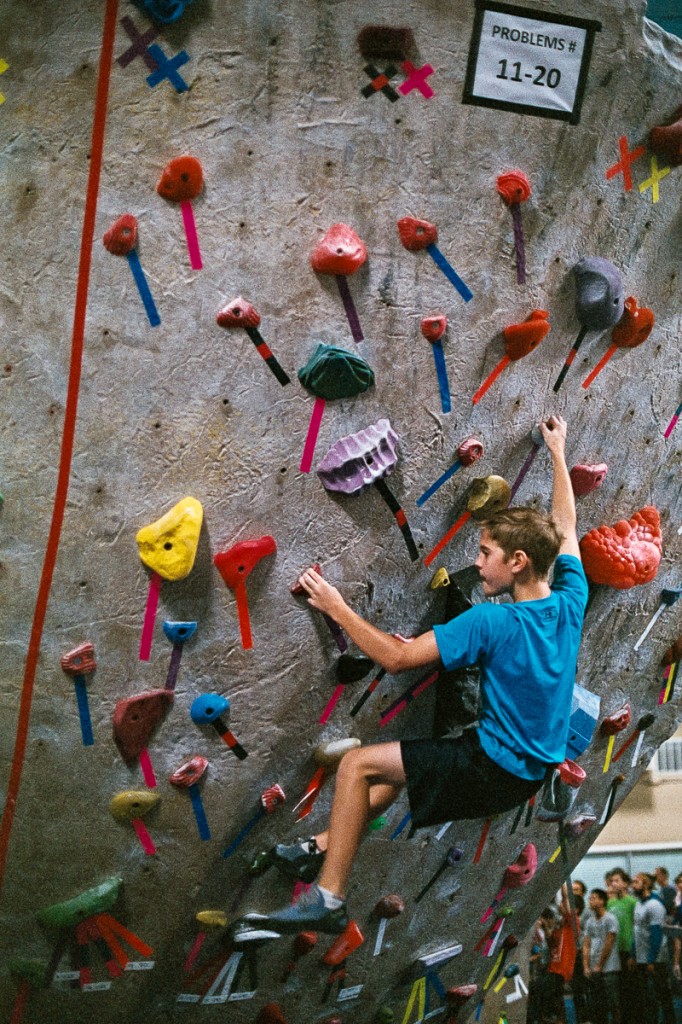 A contestant pushes himself to reach for that next hold