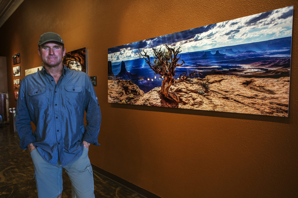 A man standing in a museum dressed in KUHL mens hiking clothing