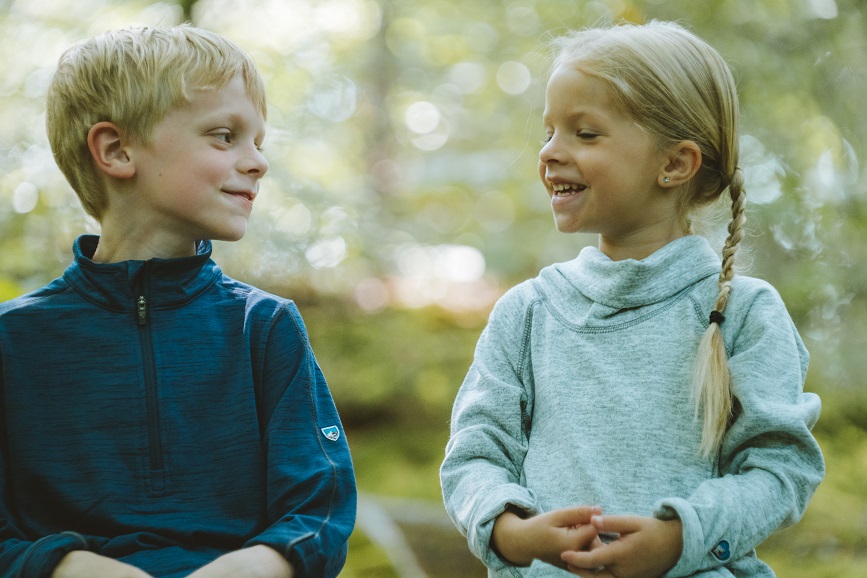 Have We Domesticated the Wild Child - A boy and a girl sitting in a forest.