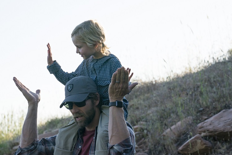 Camping Traditions - A father and his daughter sing a camping song and high-five