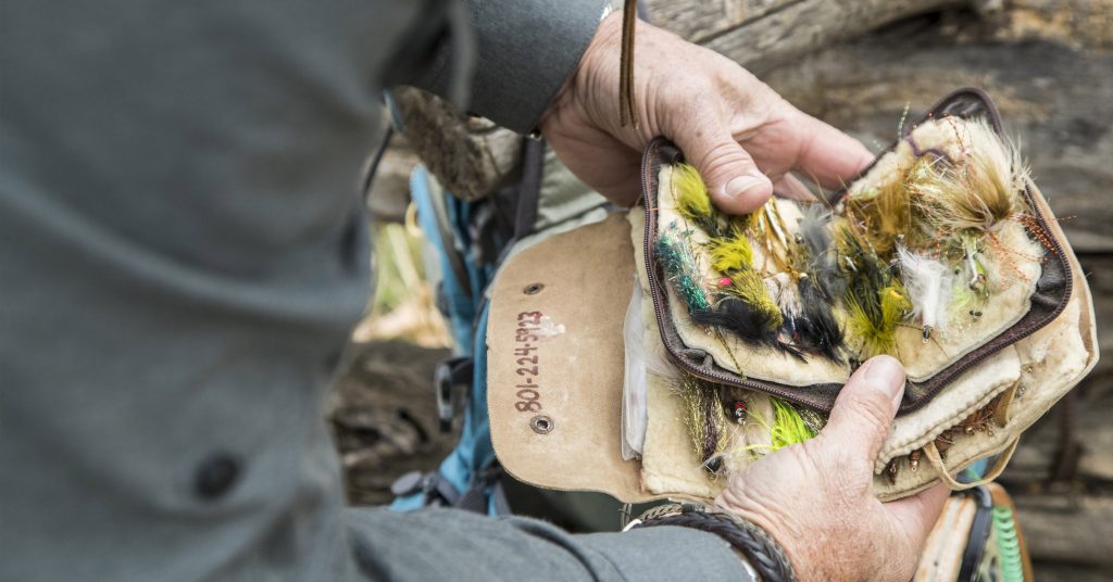 Lets Go Crawdaddin - A man holding a set of fishing baits and lures.