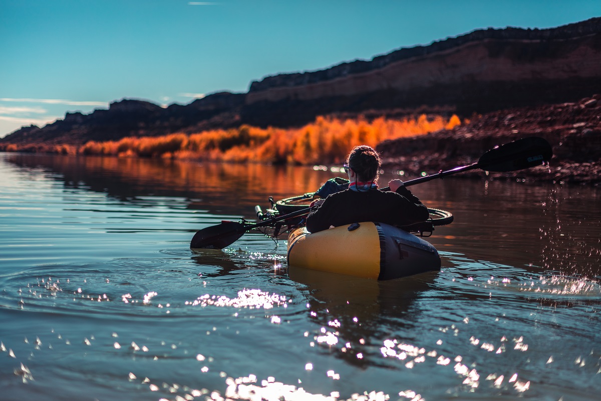 man paddling on inflatable boat