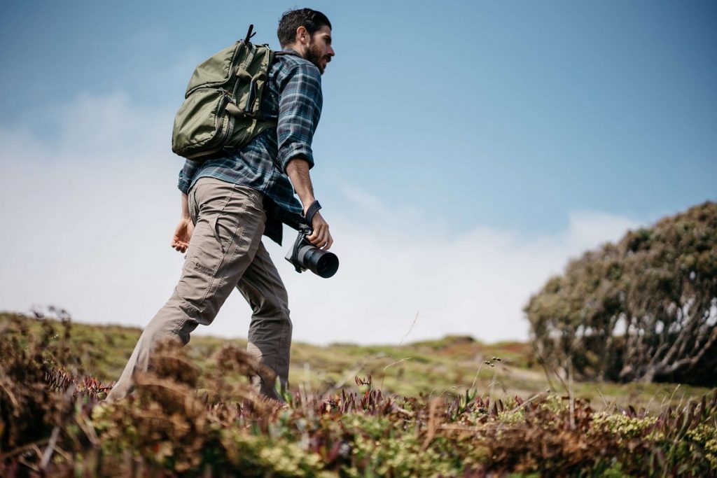 man walking with camera