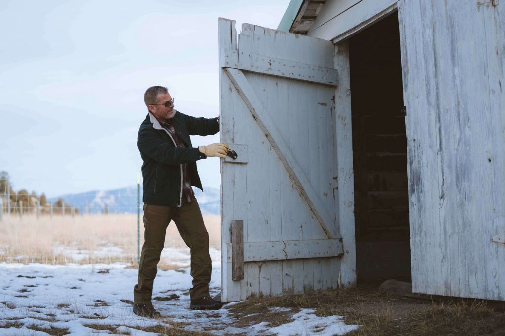 man opening a white wooden door