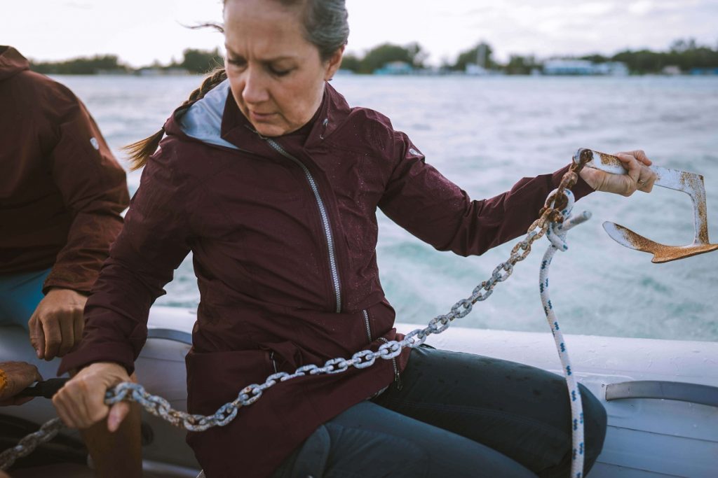 woman in a red jacket holding an anchor