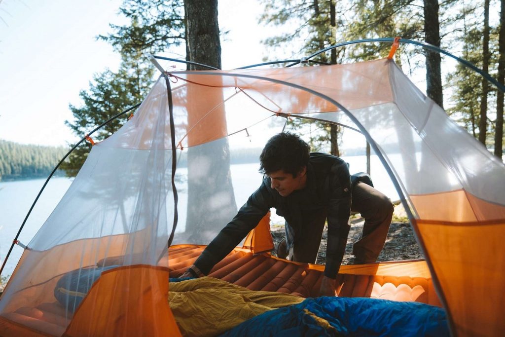 man in orange tent