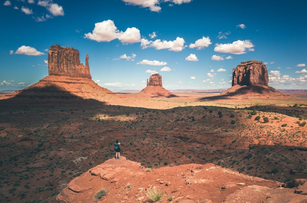 three red rock formations in desert during daytime