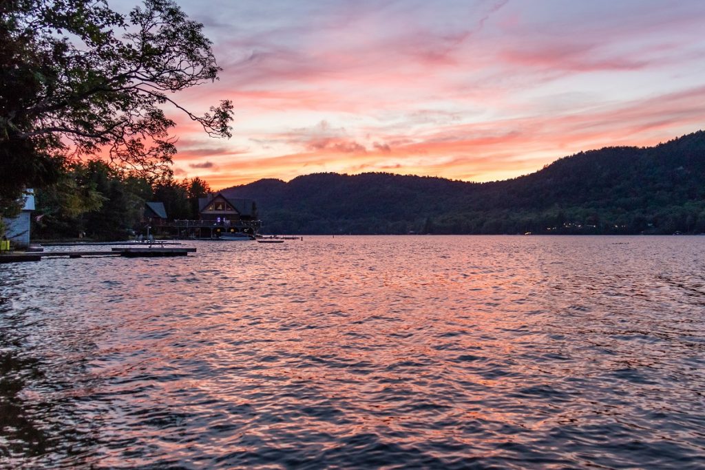 house next to pink and purple body of water 