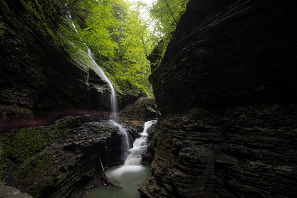 waterfall between tall rock formations