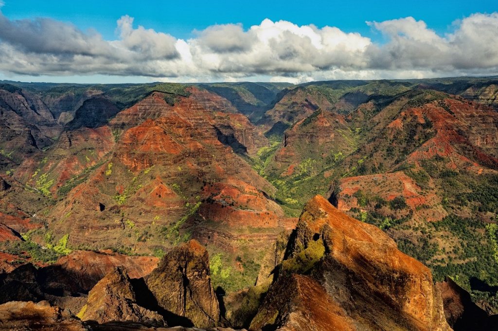 brown and green rock formations under blue sky