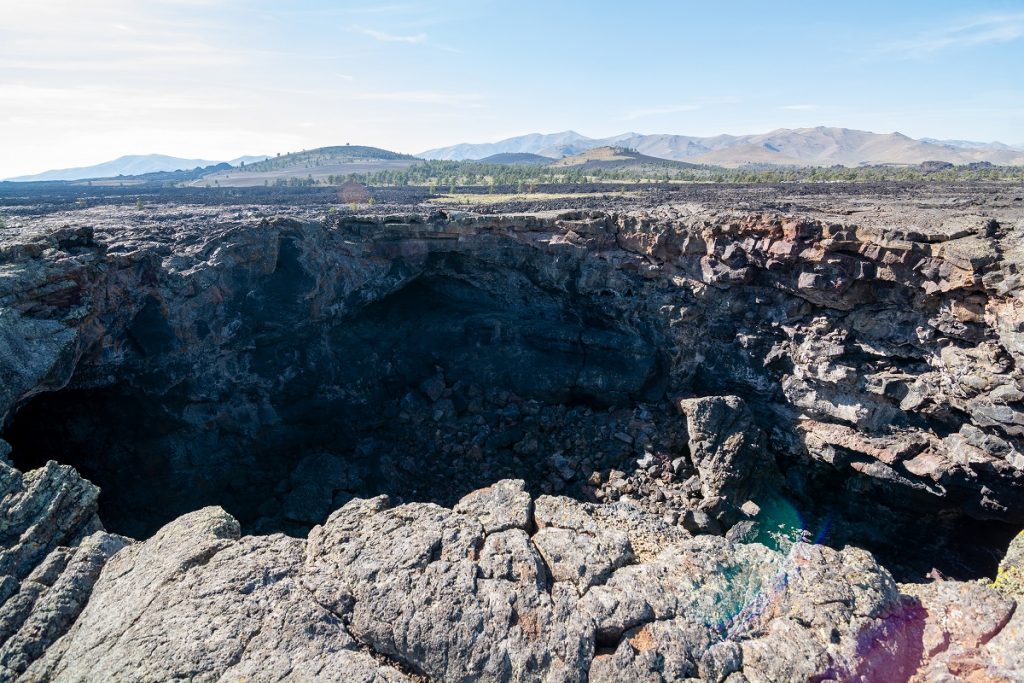 gray rock formations around a dark hole