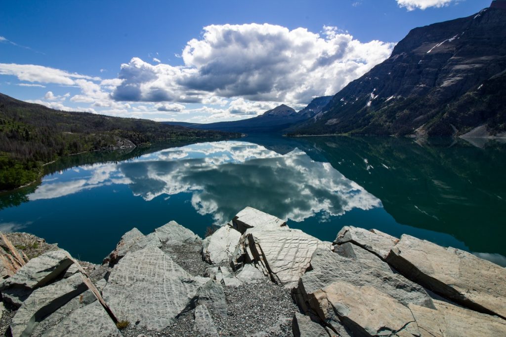 body of water under cloudy blue sky