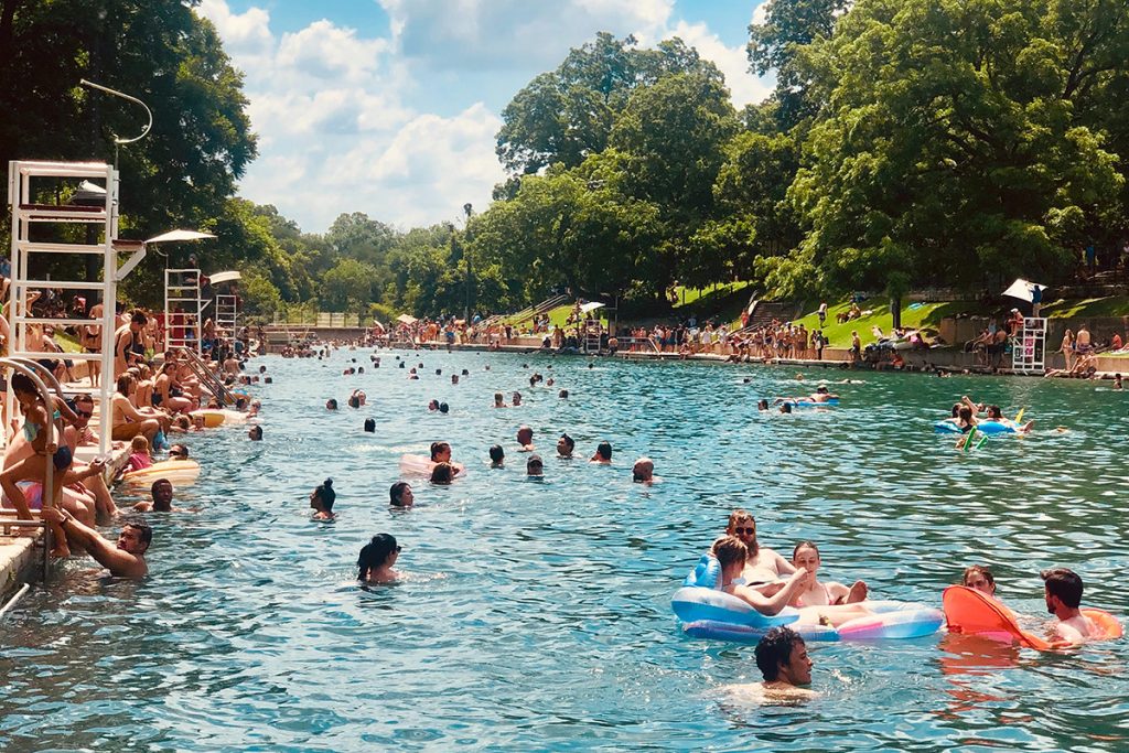 people swimming in an outdoor pool