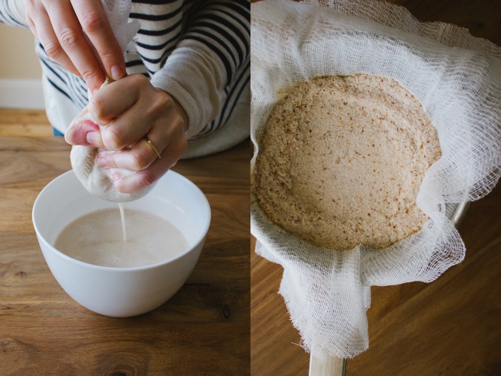 woman holding white cloth straining almond milk