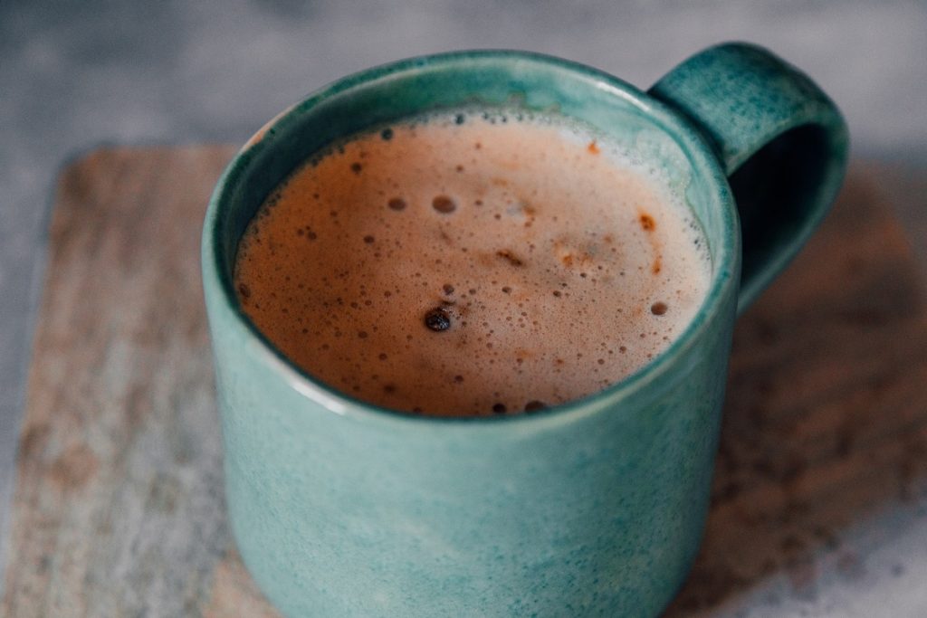 brown liquid in green mug