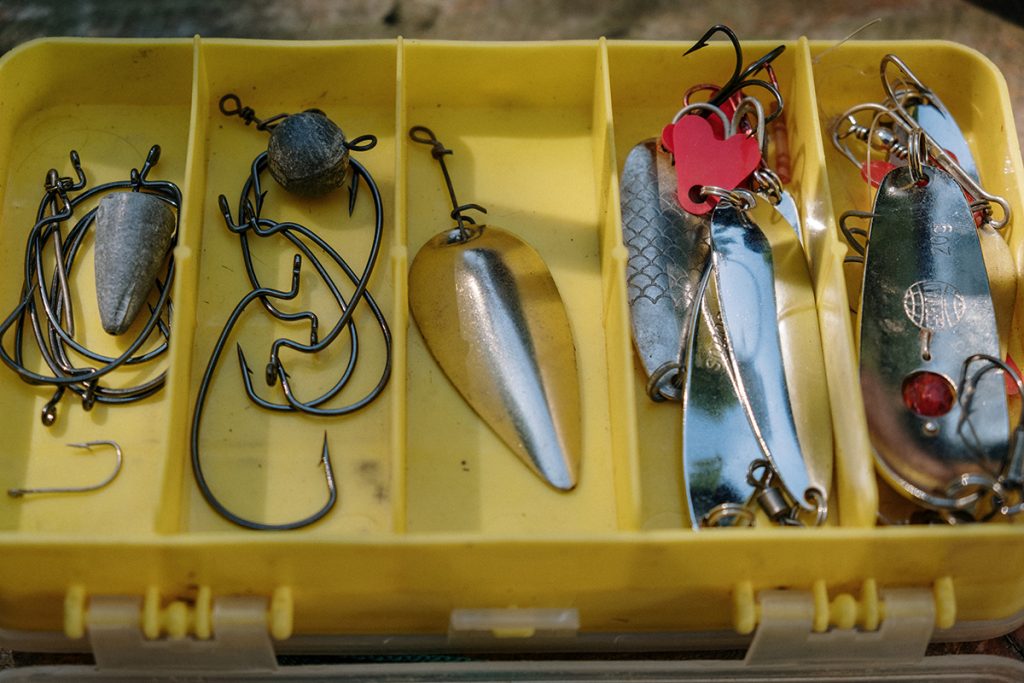 silver fishing lures in yellow box