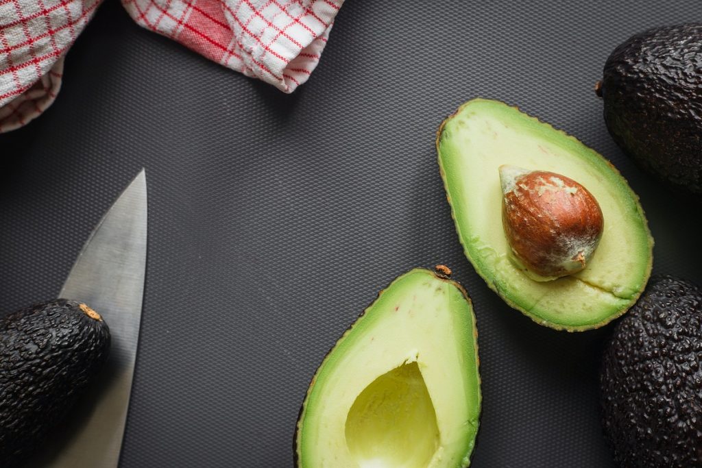 sliced avocado on black background