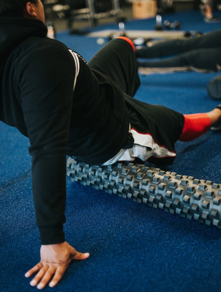 man using foam roller