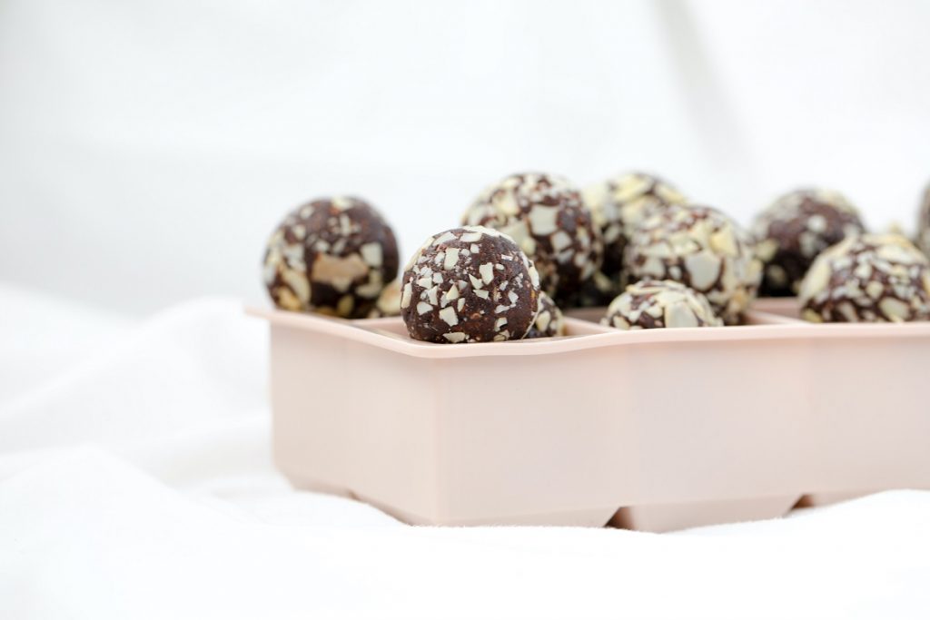 black date balls in white bowl