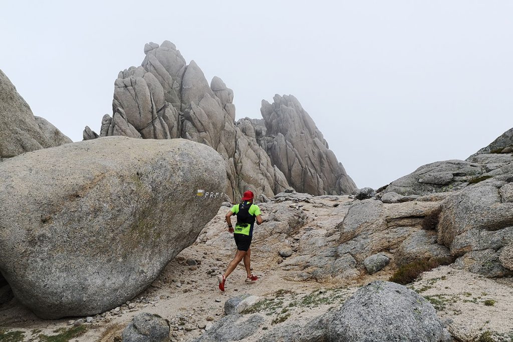 person running between rocks